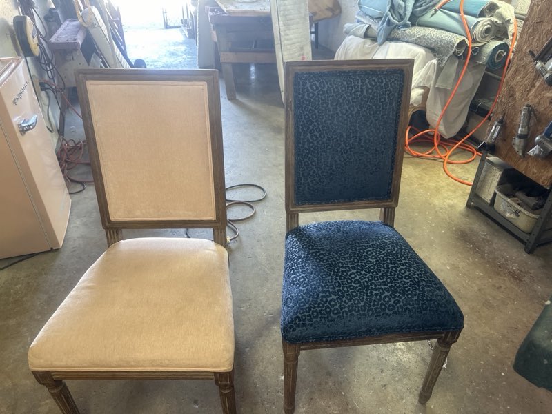 Two dining chairs side by side, one in plain cream fabric and one finished in blue leopard-print velvet